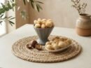 Oasis Dry Fruits Macadamia Kernels presented in a grey fluted bowl and side platter, featuring both whole kernels and natural shells for a luxury aesthetic.
