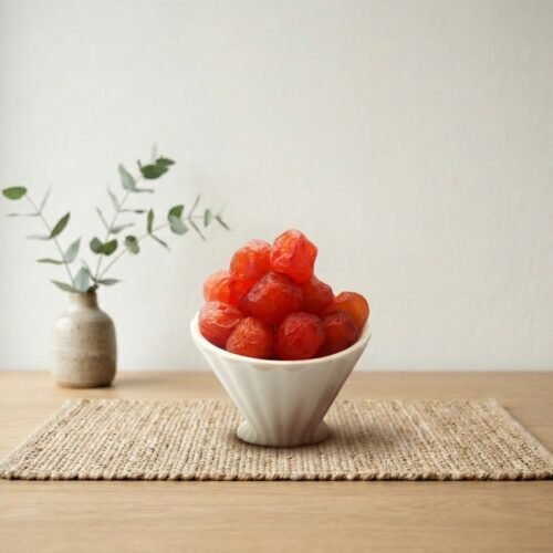 Oasis Dry Fruits premium Roseberry Plum dried in a white bowl, showcasing the vibrant ruby red color and succulent texture.