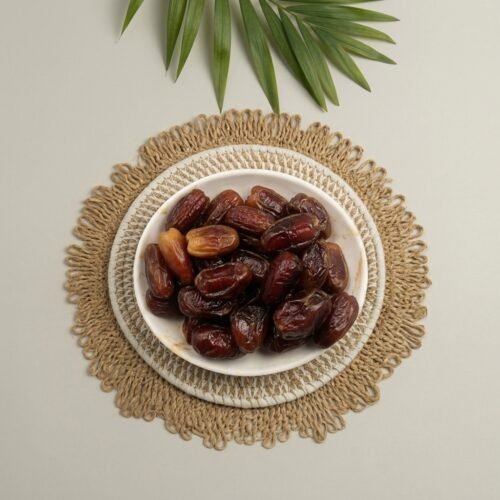 Top-down close-up of original Algerian dates on a rustic mat, showing the premium grade and fresh quality available at Oasis stores.