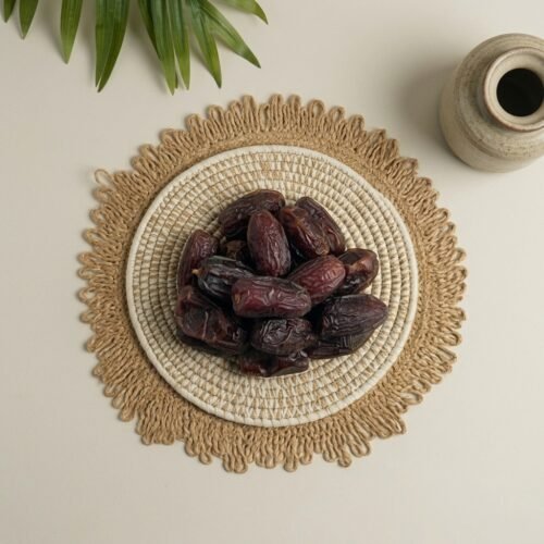 Top-down close-up of original Amber dates from Madinah, showcasing the premium skin quality and large size.