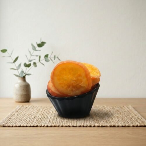 Premium natural dried mango slices by Oasis Dry Fruits in a white plate, showcasing their sun-gold color and tender, chewy texture.