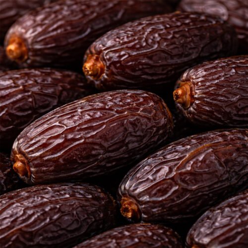 Close-up texture of Oasis Jumbo Medjool Dates showing soft moist flesh and natural caramel sweetness.