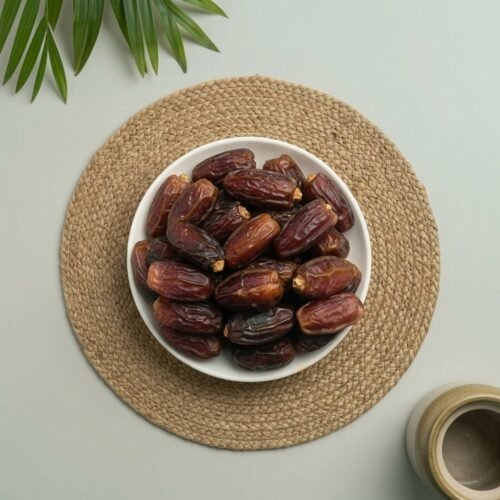 Top-down close-up shot of original Jumbo Mabroom dates, showcasing the glossy skin and premium quality available at Oasis stores.