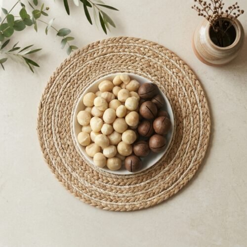 Top-down close-up of original macadamia nuts with shell, available in 250g and 500g packs at Oasis Dry Fruits stores in Bangalore.