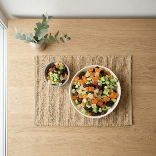 Top-down view of a colorful mix of dried fruit pieces on a rustic jute mat, highlighting the high-quality variety available at Oasis Dry Fruits.