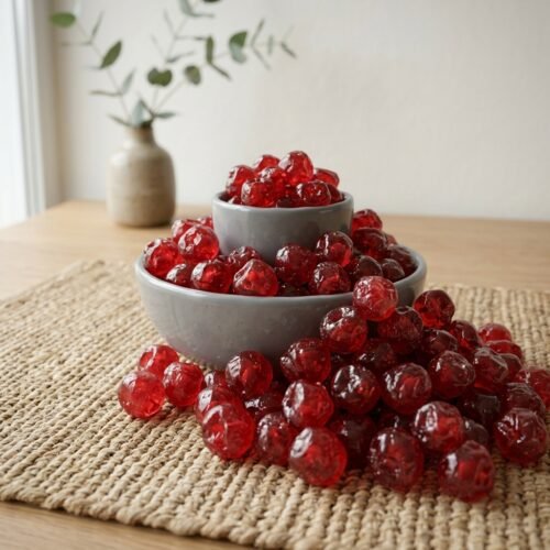 Premium dried cherries by Oasis Dry Fruits in a white bowl, showcasing their vibrant deep red color and plump, moist texture.