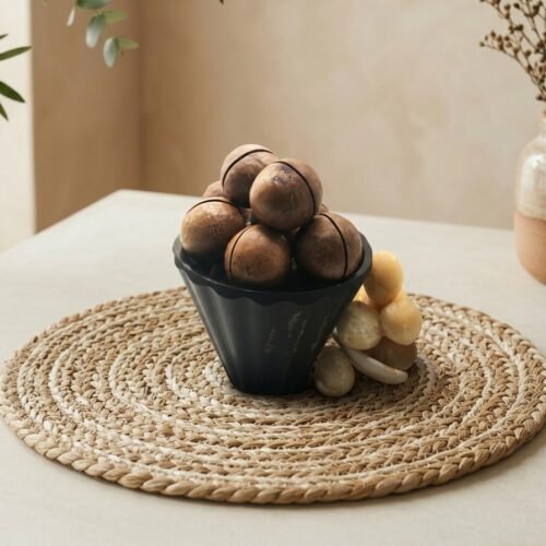 Premium macadamia nuts with shell by Oasis Dry Fruits, featuring a smooth, round dark brown shell protecting the creamy kernel.