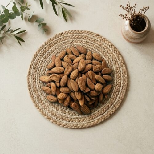 Top-down close-up of original Iran Mamra A5 kernels, available in 250g and 500g packs at Oasis Dry Fruits Bangalore.