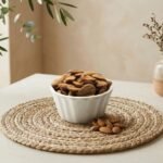 Premium Iran Mamra A5 almonds by Oasis Dry Fruits, showcasing the classic long concave shape and rich golden-brown skin.