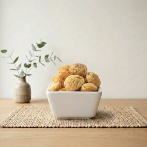 Side angle shot of natural Apricot Dried (Whole) served in a square dish by Oasis Dry Fruits.