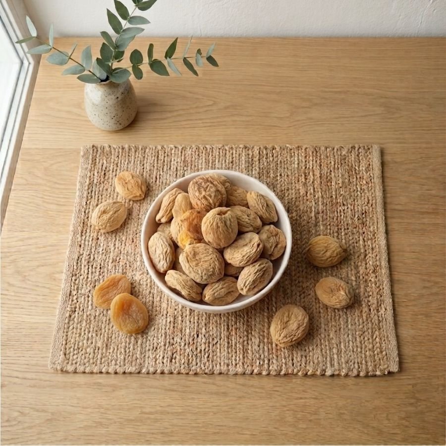 Top view flat lay of premium Apricot Dried (Whole) in a white dish by Oasis Dry Fruits.