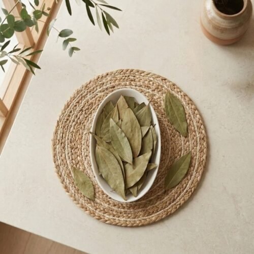 Top view flat lay of premium whole Bay Leaves in an oval dish by Oasis Dry Fruits.