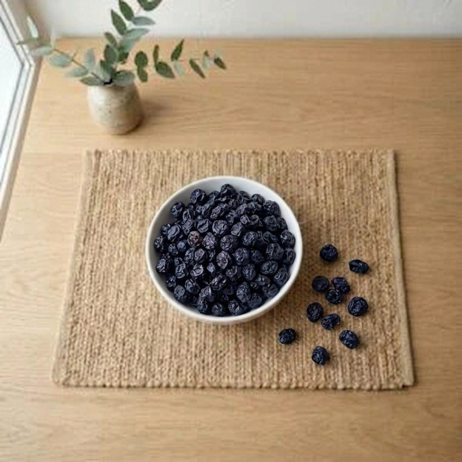 Top view flat lay of organic blue berry dried in a bowl by Oasis Dry Fruits.