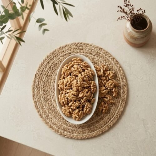 Top view flat lay of raw chile walnut without shell in a bowl by Oasis Dry Fruits.
