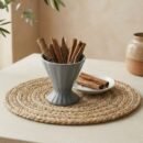 Natural whole Cinnamon Stick quills served in a grey pedestal cup by Oasis Dry Fruits.