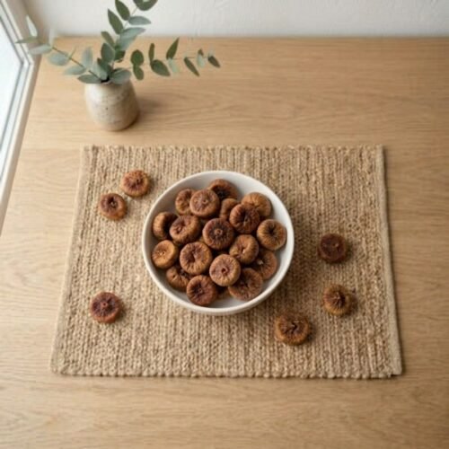 Top view flat lay of organic dried figs baby small in a bowl by Oasis Dry Fruits.