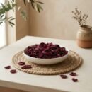 Side angle lifestyle view of organic dried rose petals in a bowl by Oasis Dry Fruits.