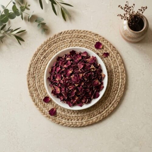 Top view flat lay of organic dried rose petals in a white bowl by Oasis Dry Fruits.