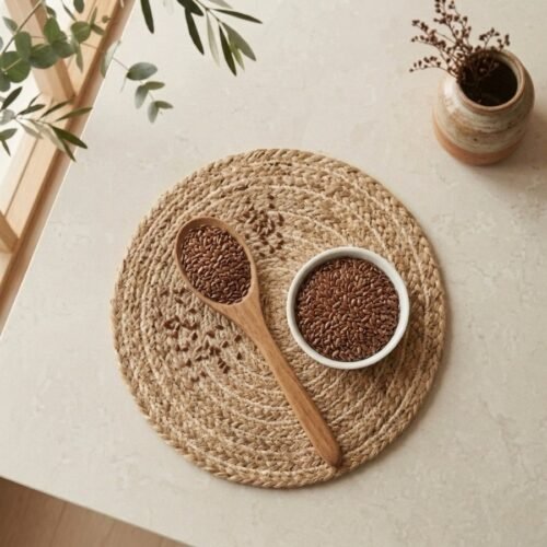 Top view flat lay of raw flax seeds in a white bowl with wooden spoon by Oasis Dry Fruits.