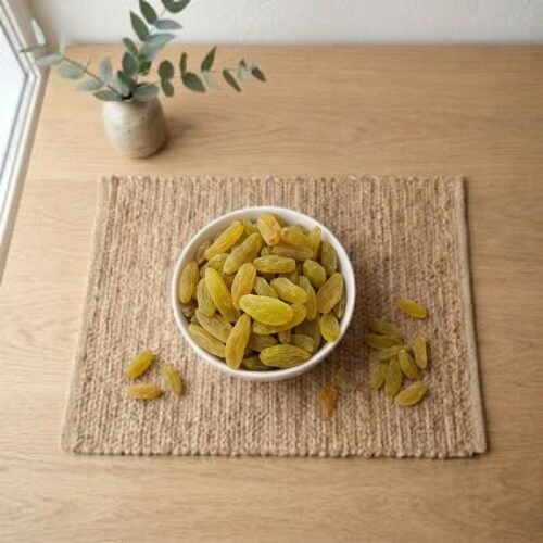Top view flat lay of organic Indian Premium Golden Raisins by Oasis Dry Fruits.