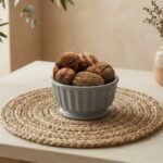 Raw kashmiri walnut with shell filled in a grey ceramic bowl by Oasis Dry Fruits.