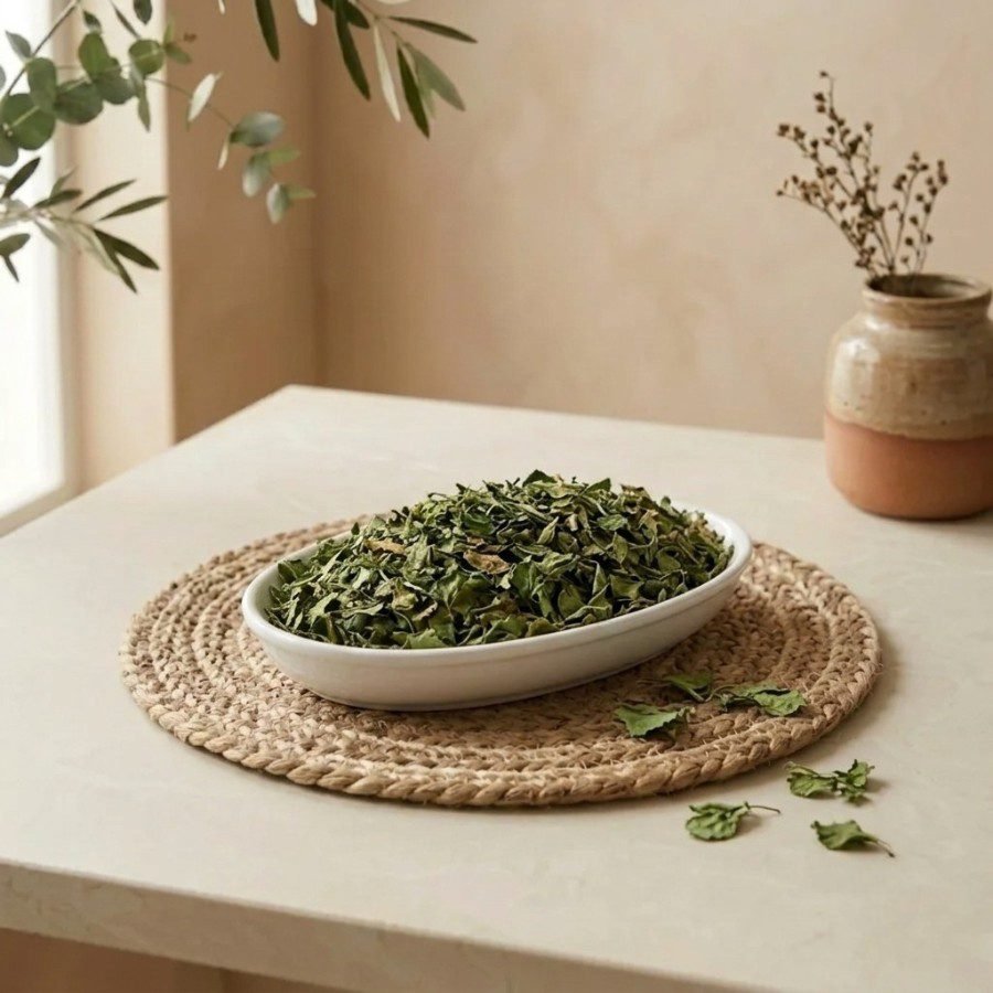 Side angle lifestyle shot of Kasuri Methi in an oval dish by Oasis Dry Fruits.