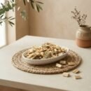 Side angle lifestyle view of natural kavasiya in an oval dish by Oasis Dry Fruits.