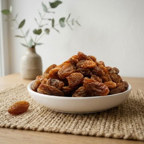 Premium organic Munakka served in a white ceramic bowl by Oasis Dry Fruits.
