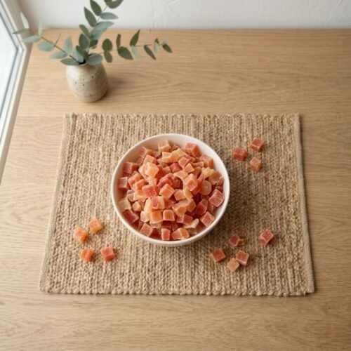 Top view flat lay of sweet Papaya (Dried) cubes in a bowl by Oasis Dry Fruits.