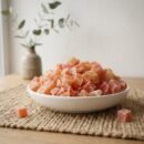 Delicious Papaya (Dried) cubes served in a white ceramic bowl by Oasis Dry Fruits.