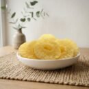 Side angle lifestyle shot of sweet Pineapple (Dried) rings in a white bowl by Oasis Dry Fruits.