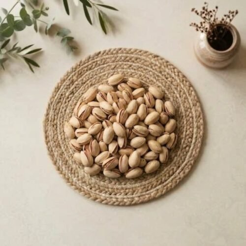 Top view flat lay of premium pista california large on a woven mat by Oasis Dry Fruits.