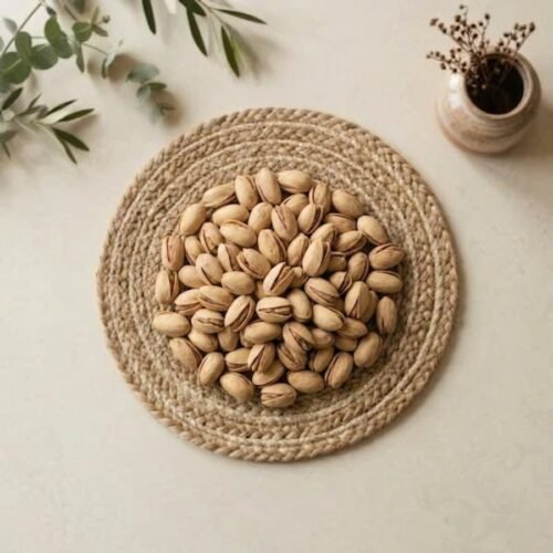 Top view flat lay of premium pista california on a woven mat by Oasis Dry Fruits.