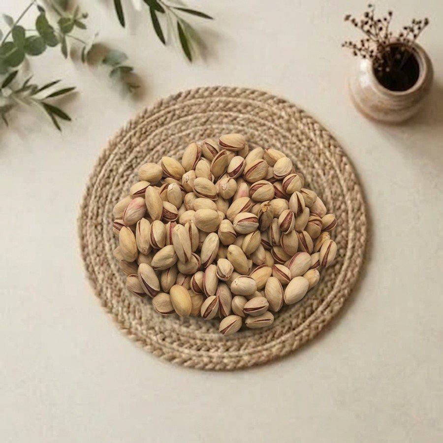 Top view flat lay of authentic pista iran on a woven mat by Oasis Dry Fruits.
