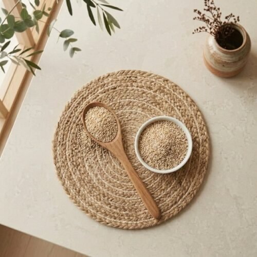 Top view flat lay of premium white poppy seeds in a bowl with wooden spoon by Oasis Dry Fruits.