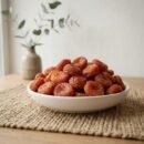 Organic Red Apricot (Ladakh) served in a white ceramic bowl by Oasis Dry Fruits.