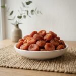Organic Red Apricot (Ladakh) served in a white ceramic bowl by Oasis Dry Fruits.
