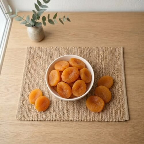 Top view flat lay of soft Turkey Apricots in a white bowl by Oasis Dry Fruits.