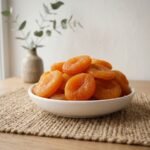 Premium sun-dried Turkey Apricots served in a white ceramic bowl by Oasis Dry Fruits.