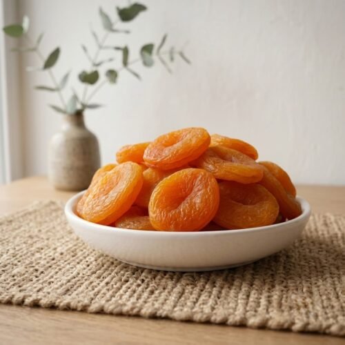 Premium sun-dried Turkey Apricots served in a white ceramic bowl by Oasis Dry Fruits.