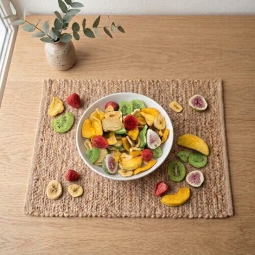 Top view flat lay of colorful Fruit Mix Dehydrated on a placemat by Oasis Dry Fruits.