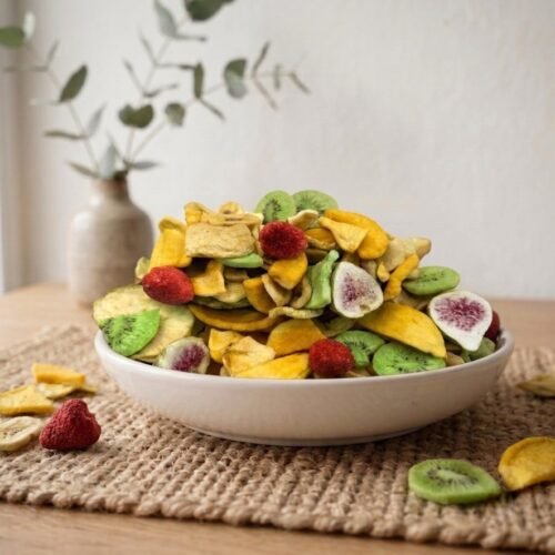 Side angle lifestyle shot of premium Fruit Mix Dehydrated in a white bowl by Oasis Dry Fruits.