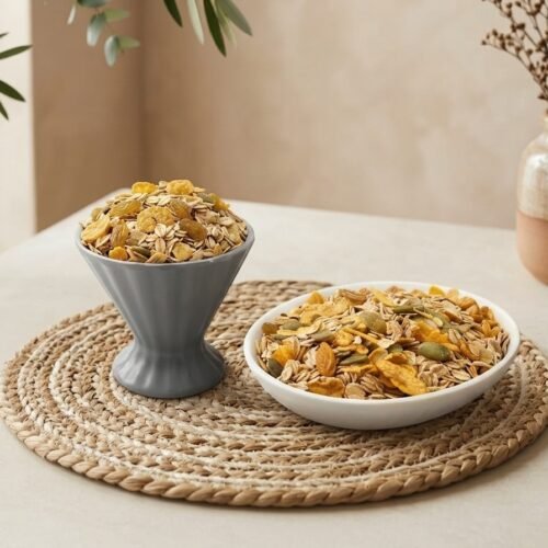 Side angle lifestyle shot of crunchy Muesli Honey served in dual bowls by Oasis Dry Fruits.