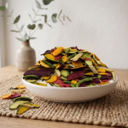 Side angle lifestyle shot of crispy Vegetable Mix Salted Dehydrated in a bowl by Oasis Dry Fruits.