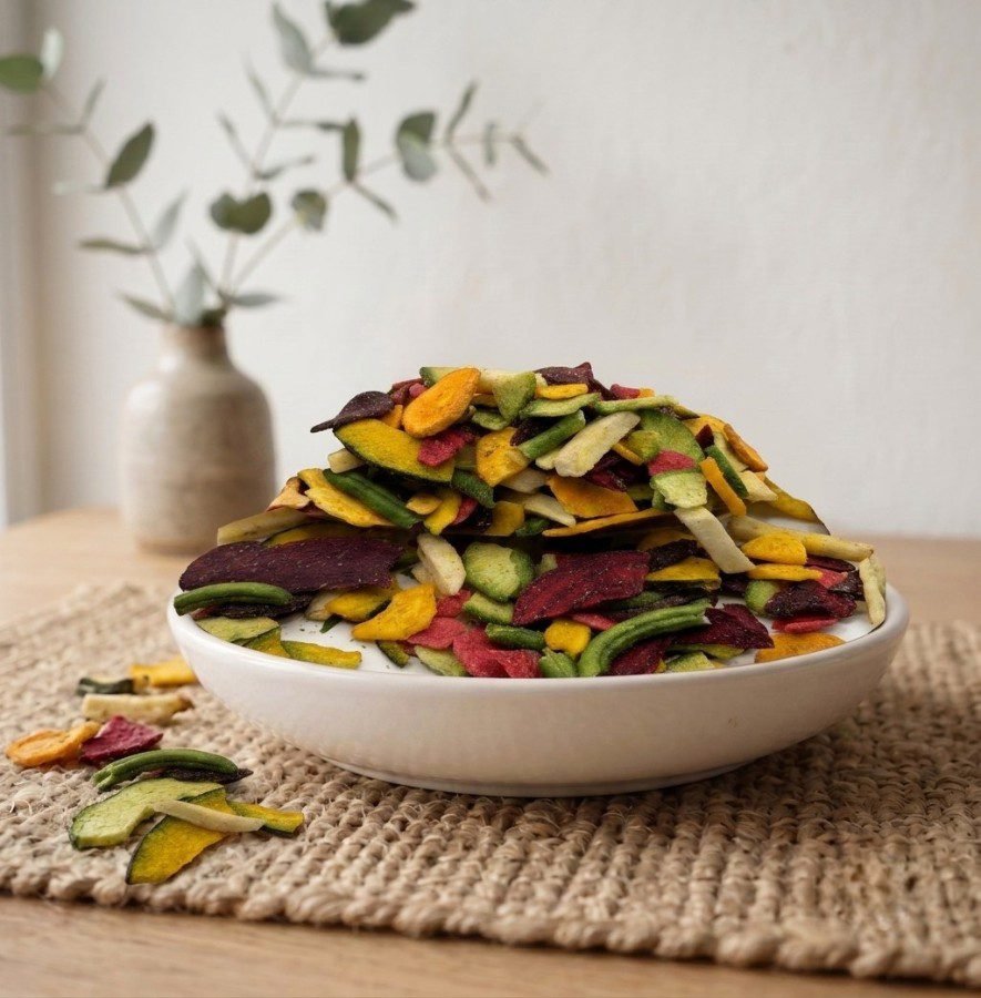 Side angle lifestyle shot of crispy Vegetable Mix Salted Dehydrated in a bowl by Oasis Dry Fruits.