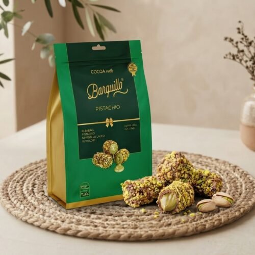 Cocoa Melts Pistachio 100g pouch with pistachio-crusted wafer rolls on a jute mat
