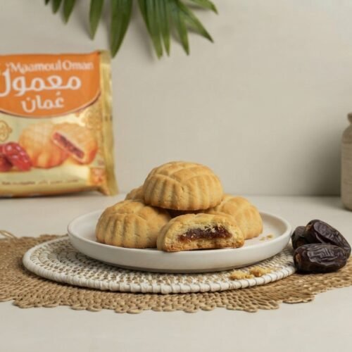 Maamoul Oman Date Filled Cookies on a plate, one broken to show date filling
