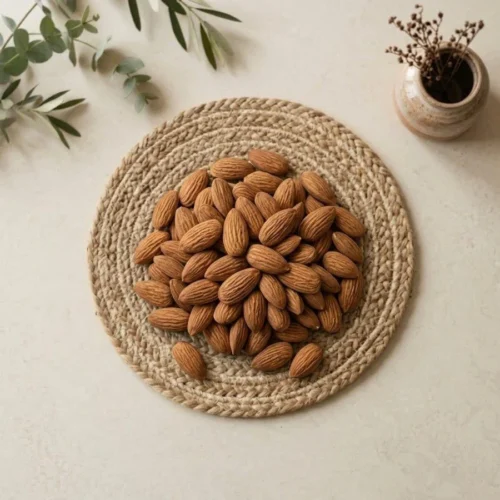 Top view flat lay of raw organic Kashmiri Almonds on a mat by Oasis Dry Fruits.