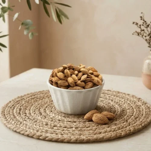 Side angle lifestyle shot of Kashmiri Almonds With Shells in a bowl by Oasis Dry Fruits.