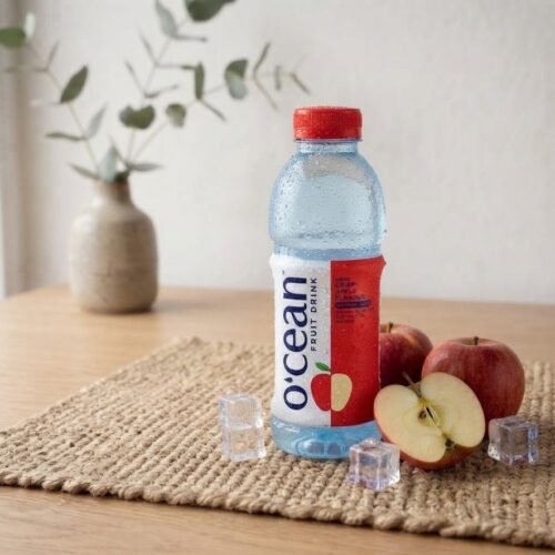 Ocean Fruit Drink Apple chilled bottle with fresh red apples and ice cubes